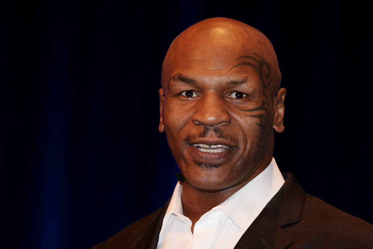 mike tyson speaks on stage at an event