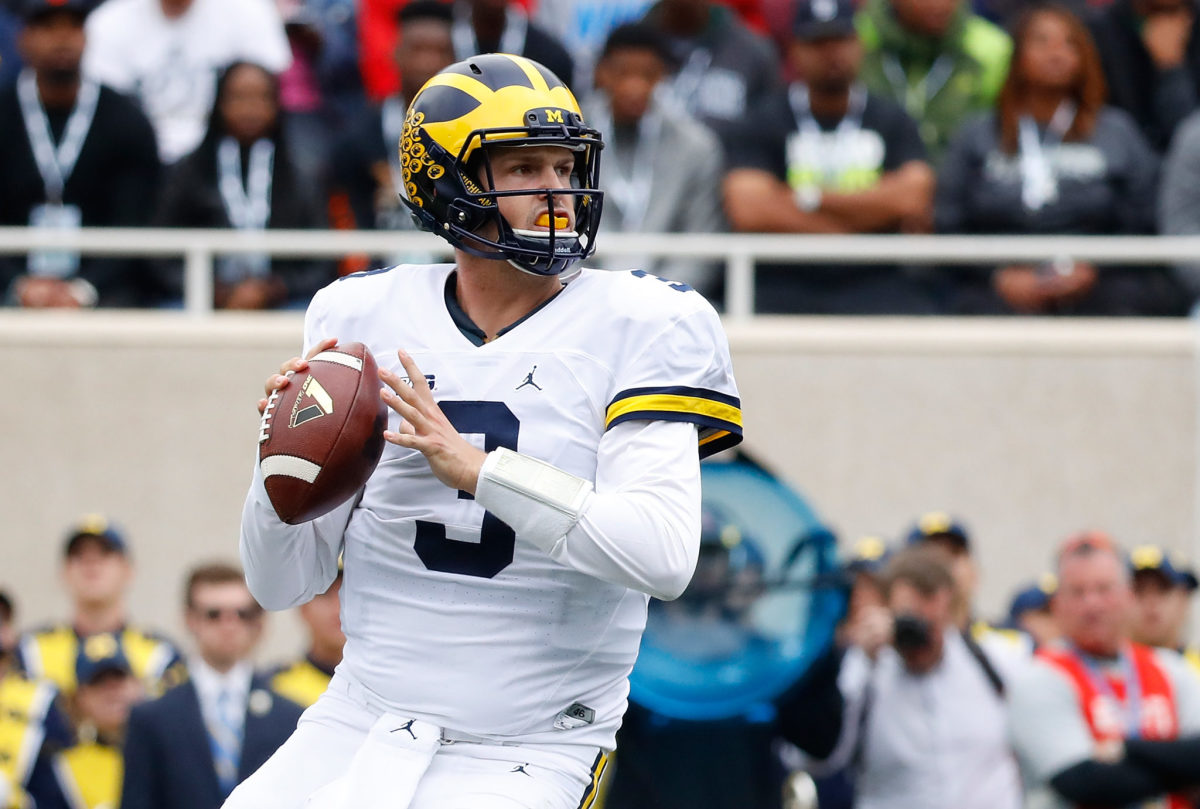 Wilton Speight of the Michigan Wolverines drops back to pass during the second quarter of the game against the Michigan State Spartans.