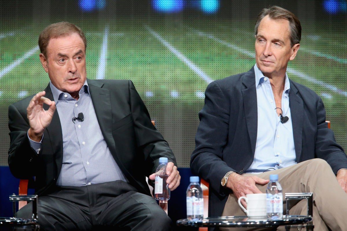 Cris Collinsworth and Al Michaels speaking onstage.