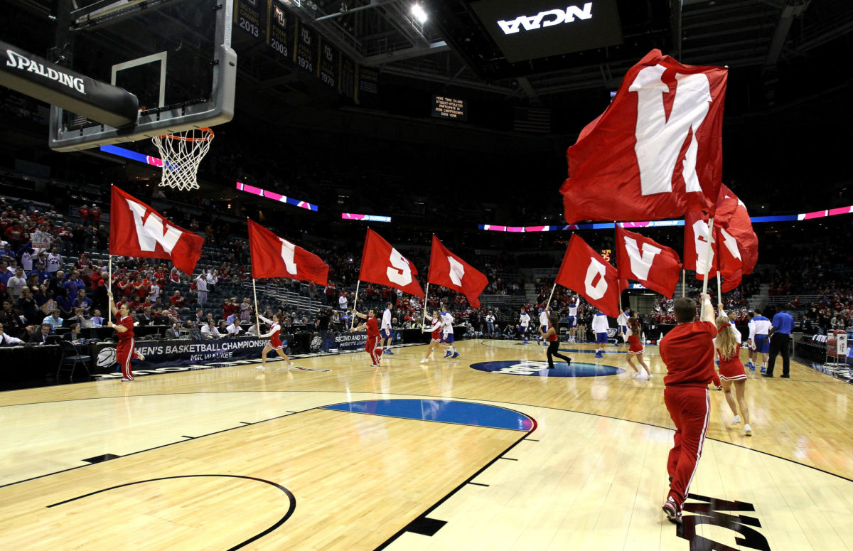Wisconsin basketball cheerleaders fly Wisconsin banners at the NCAA Tournament in 2014.