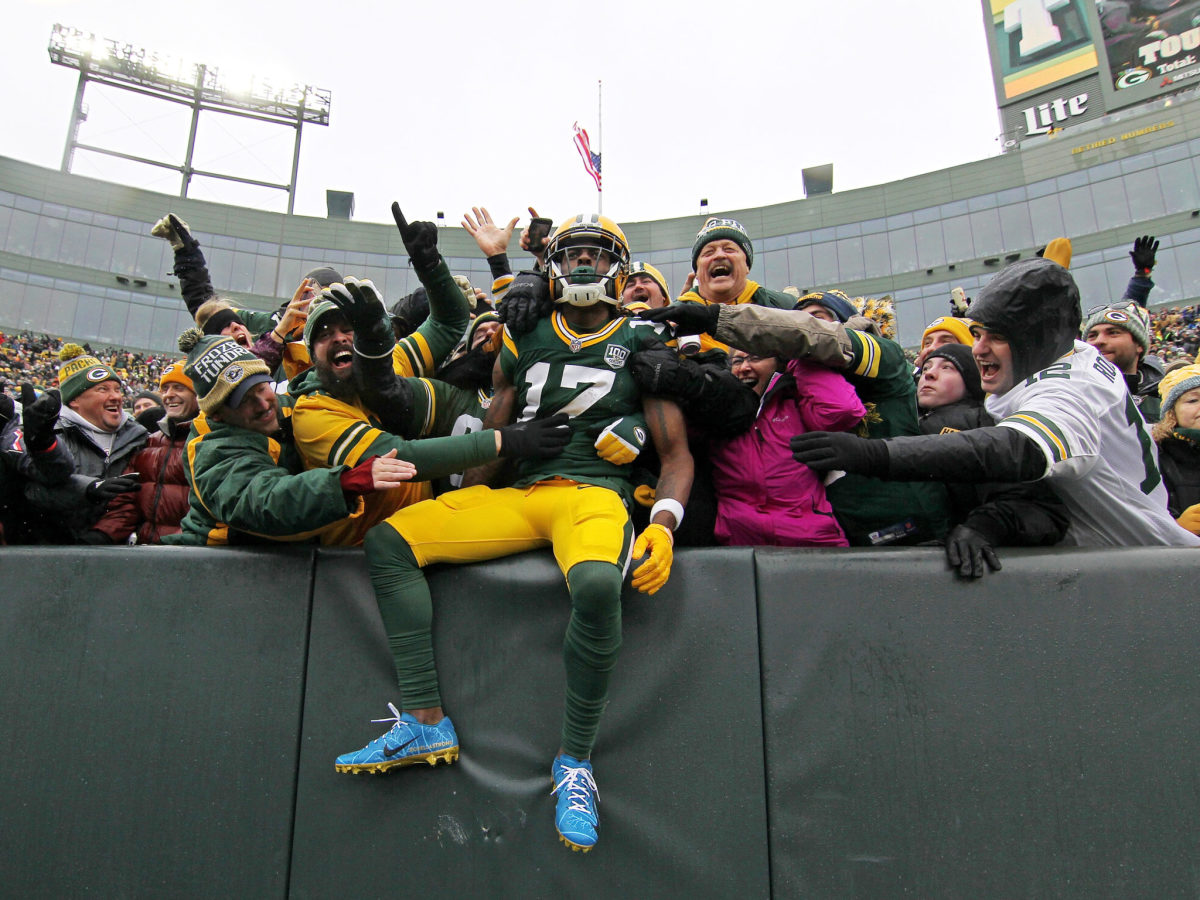 Davante Adams celebrating a touchdown with Green Bay Packers fans.