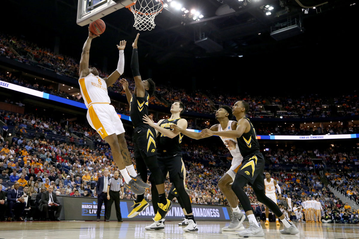 Tennessee and Iowa players battling during an NCAA Tournament game.