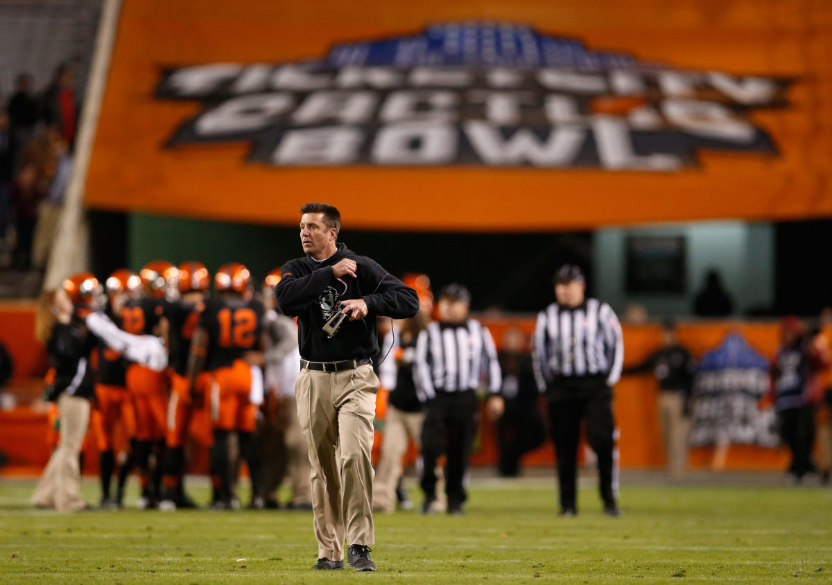 Oklahoma State head coach Mike Gundy on the field during a game.