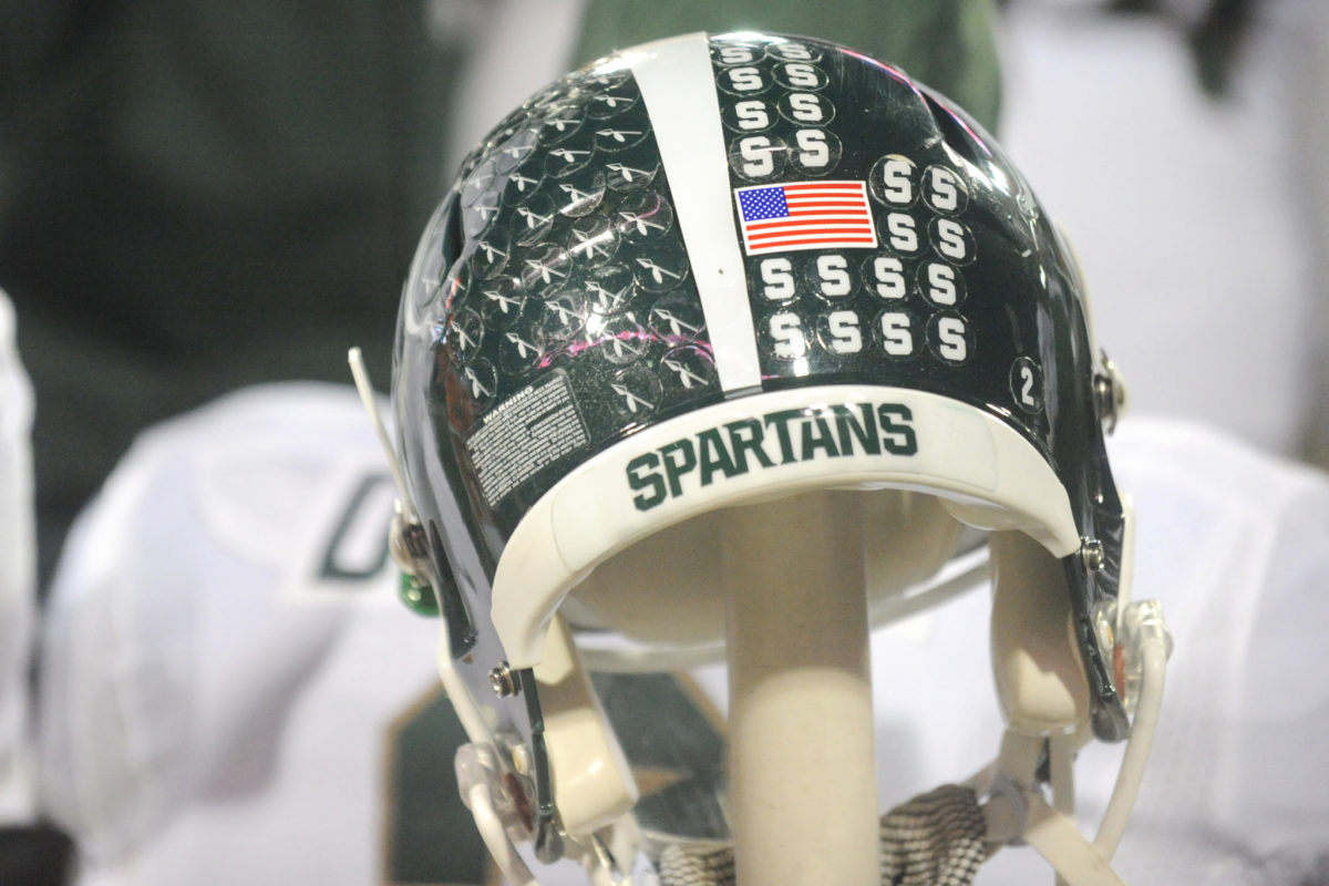 A closeup of a Michigan State Spartans football helmet.