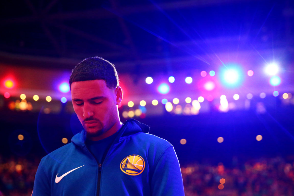Klay Thompson standing for the National Anthem.