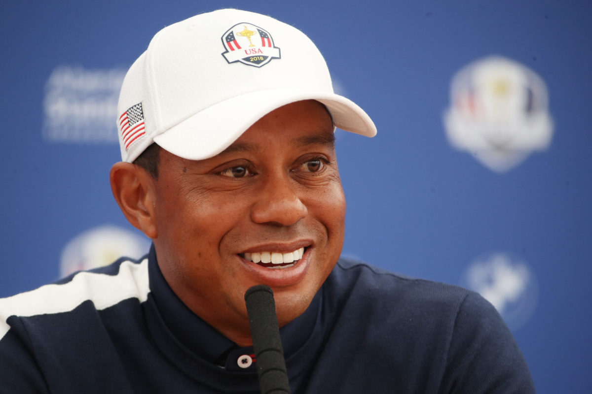 Tiger Woods smiles at a press conference.