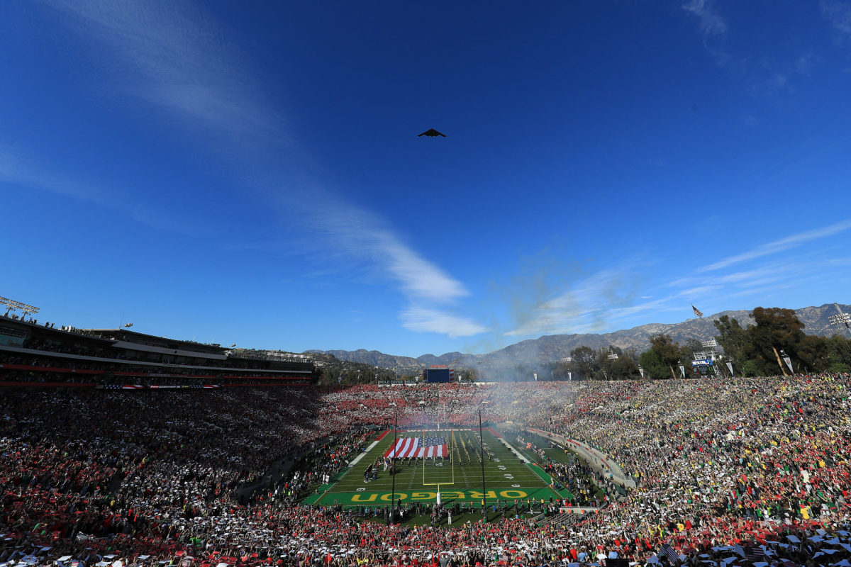 Stealth bomber flies over college football game at the Rose Bowl game between Big Ten and Pac-12 teams..