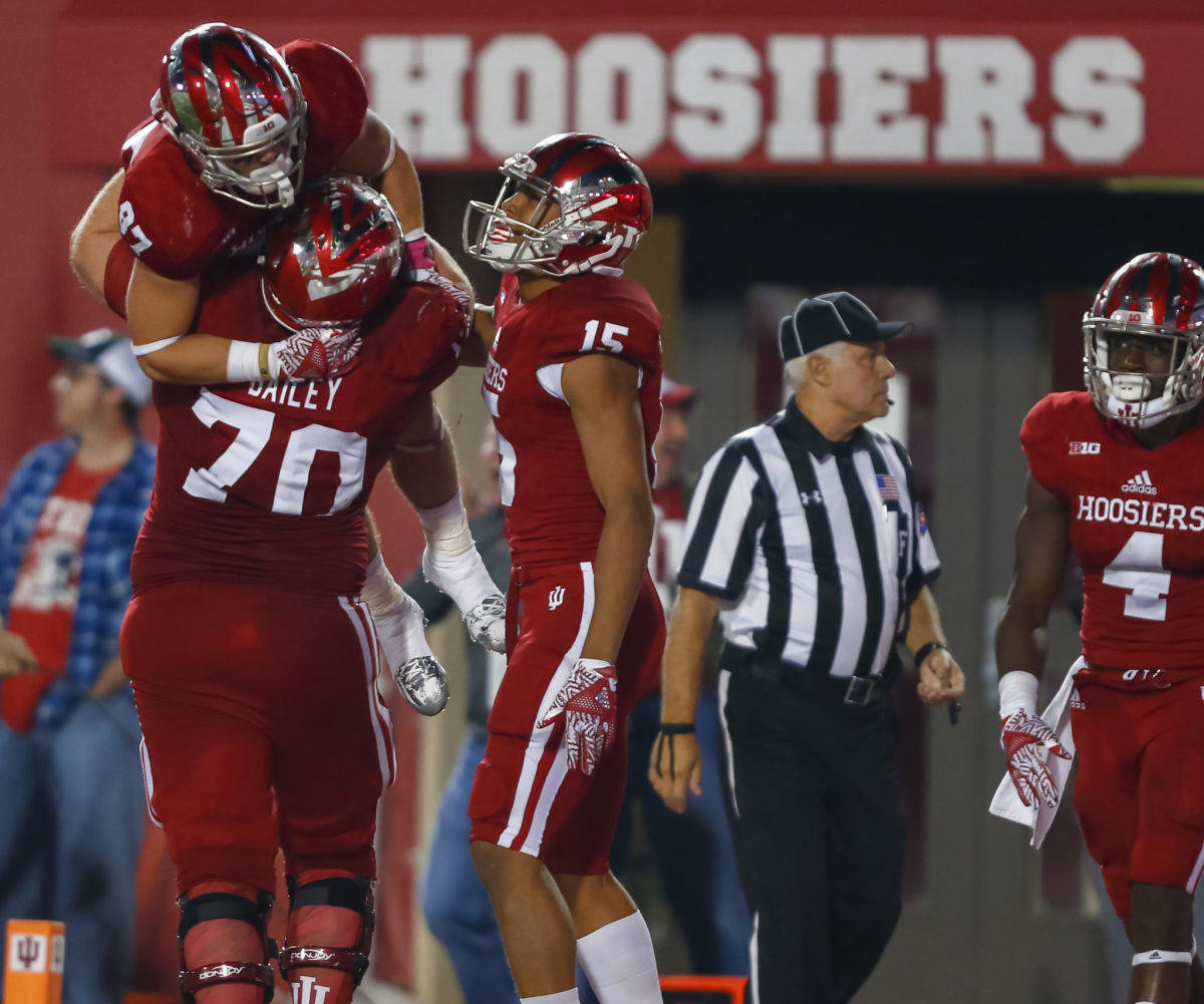 Calob Meinzer #87 celebrates in the arms of Jacob Bailey #70 of the Indiana Hoosiers after a touchdown against the Michigan State Spartans at Memorial Stadium.