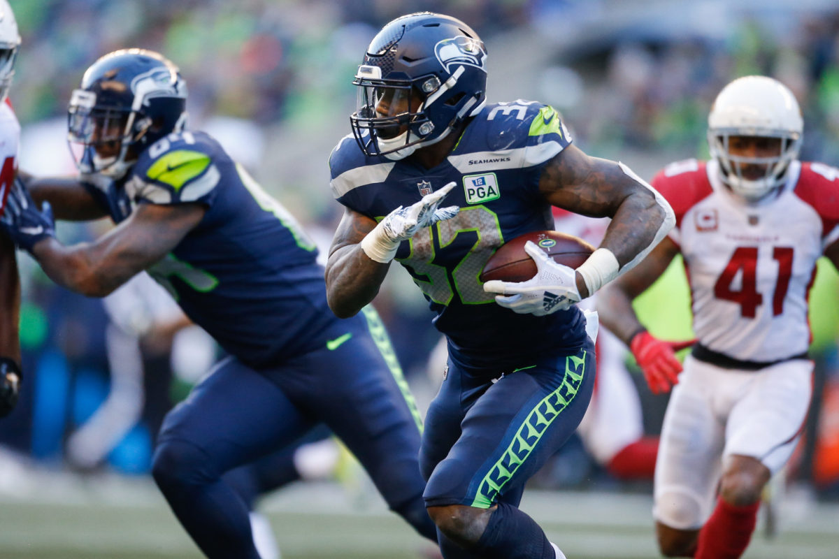 Chris Carson running the football for the Seattle Seahawks.