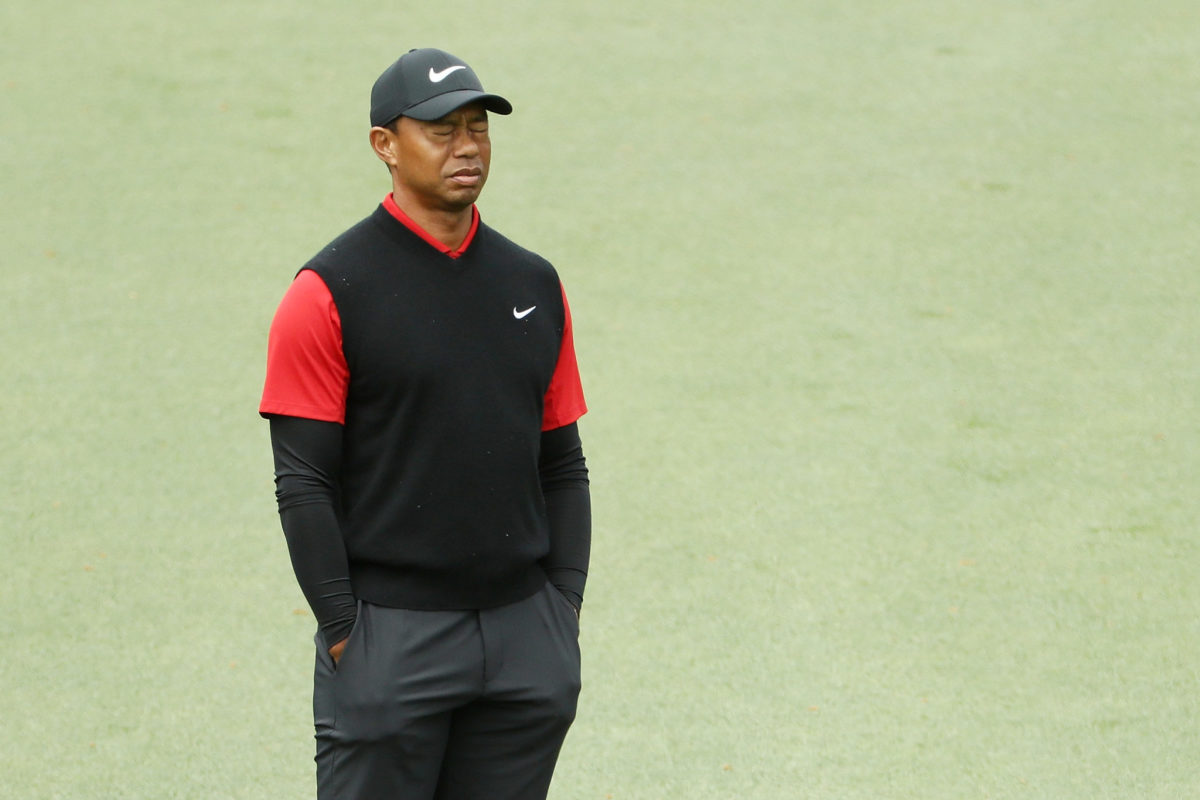 Tiger Woods closing his eyes with his hands in his pocket.