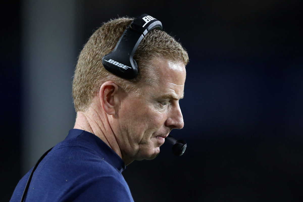 Jason Garrett stares down at the field during a game.