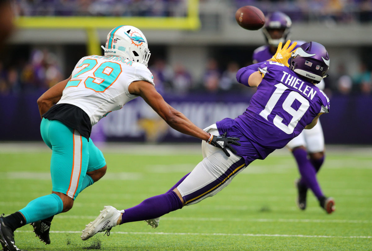 Adam Thielen catches a pass for the Vikings against the Dolphins.