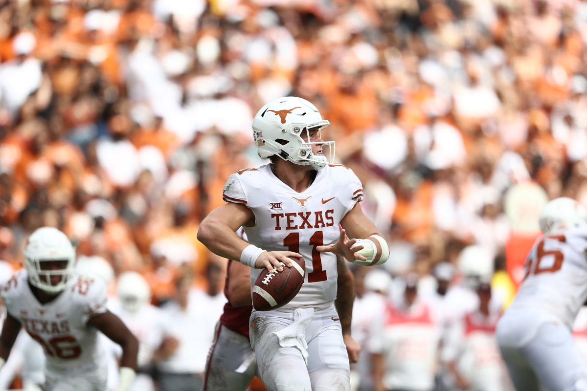 Sam Ehlinger of Texas attempts to throw a pass