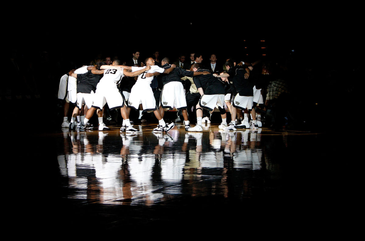 Wake Forest basketball playing huddling up before a game.