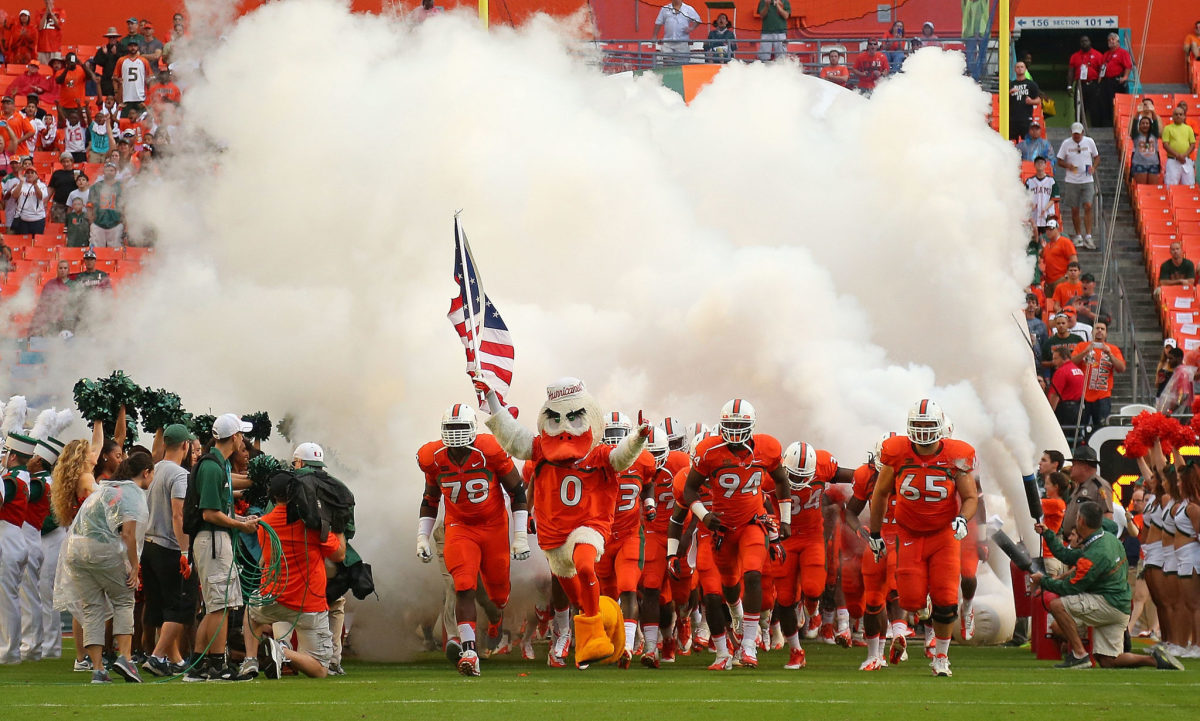 Miami players running on the field for a game.