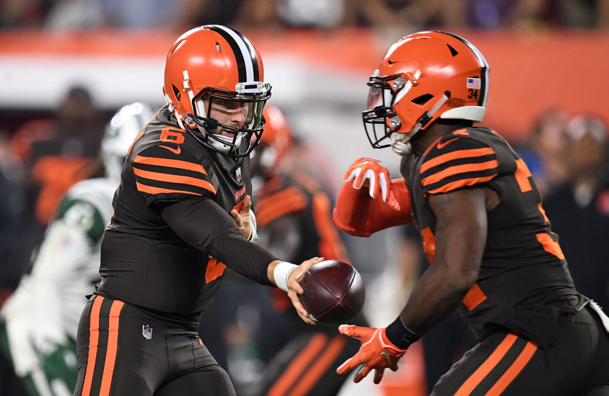 Baker Mayfield hands off to Carlos Hyde.
