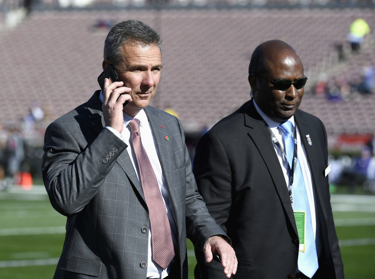 Urban speaking on a cell phone prior to a football game.