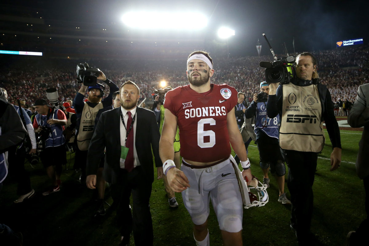 Quarterback Baker Mayfield #6 of the Oklahoma Sooners walks off the field after losing to the Georgia Bulldogs 54-48 in the 2018 College Football Playoff Semifinal at the Rose Bowl Game.
