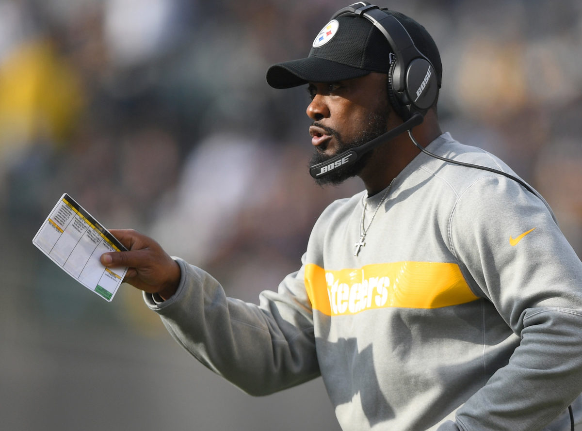 A closeup of Pittsburgh Steelers coach Mike Tomlin holding a play sheet.