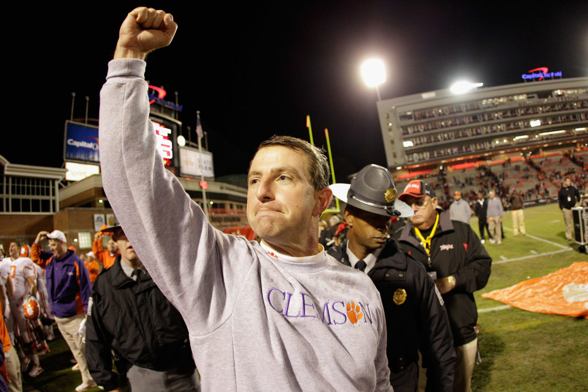 Dabo Swinney raising his arm in triumph after a 2011 college football win for Clemson over Maryland.