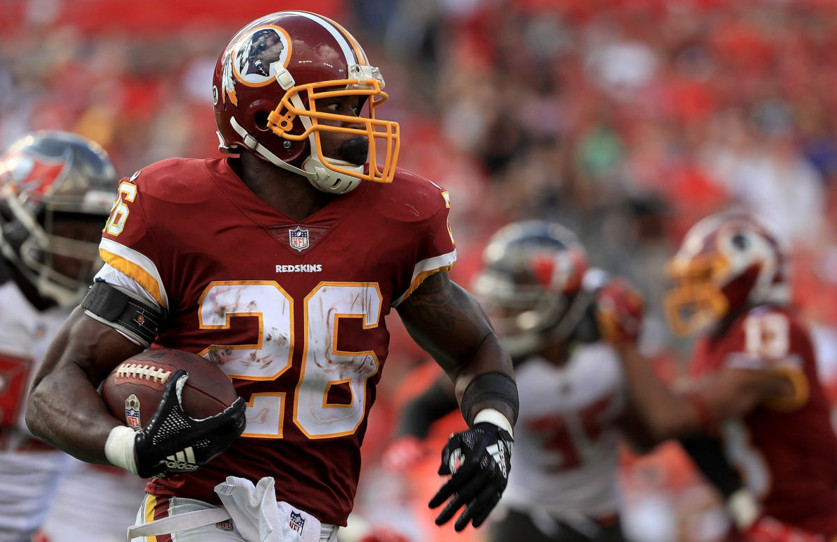 Adrian Peterson running the ball in a Redskins game.