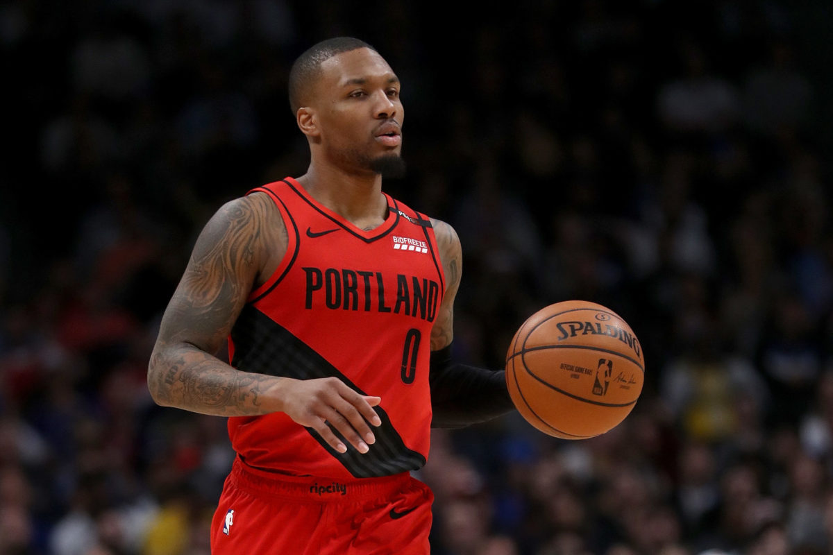 Damian Lillard dribbling the ball during a game against the Denver Nuggets in 2019.