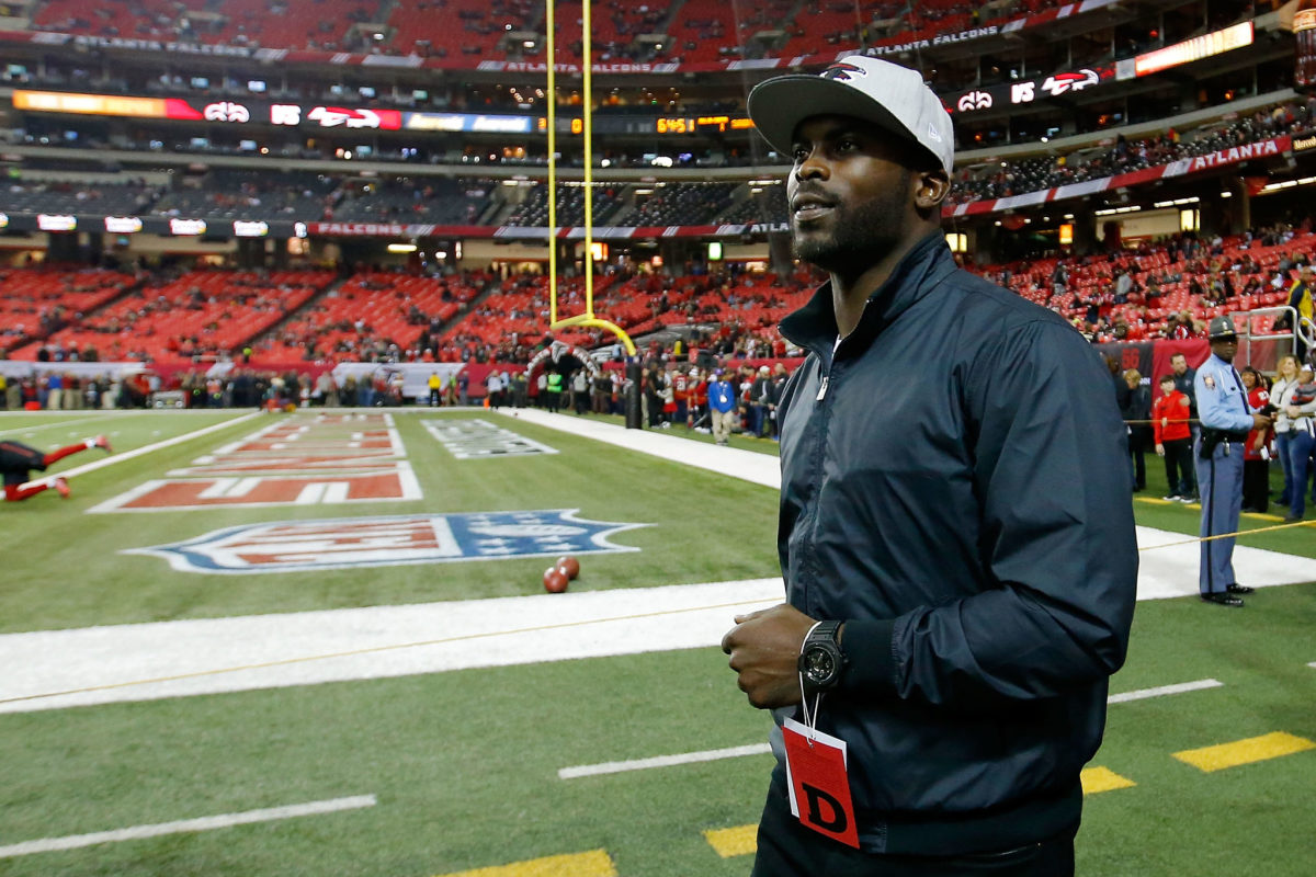 michael vick walks onto the field before a falcons game