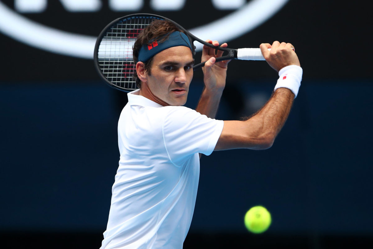 Roger Federer winds up to hit the ball.