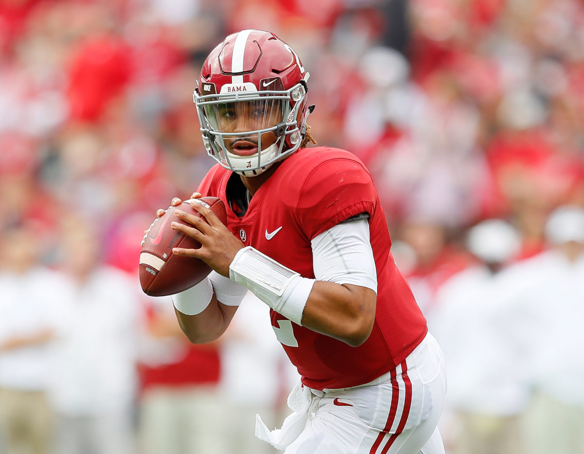 Jalen Hurts of the Alabama Crimson Tide rolls  out to pass against the Mercer Bears at Bryant-Denny Stadium.