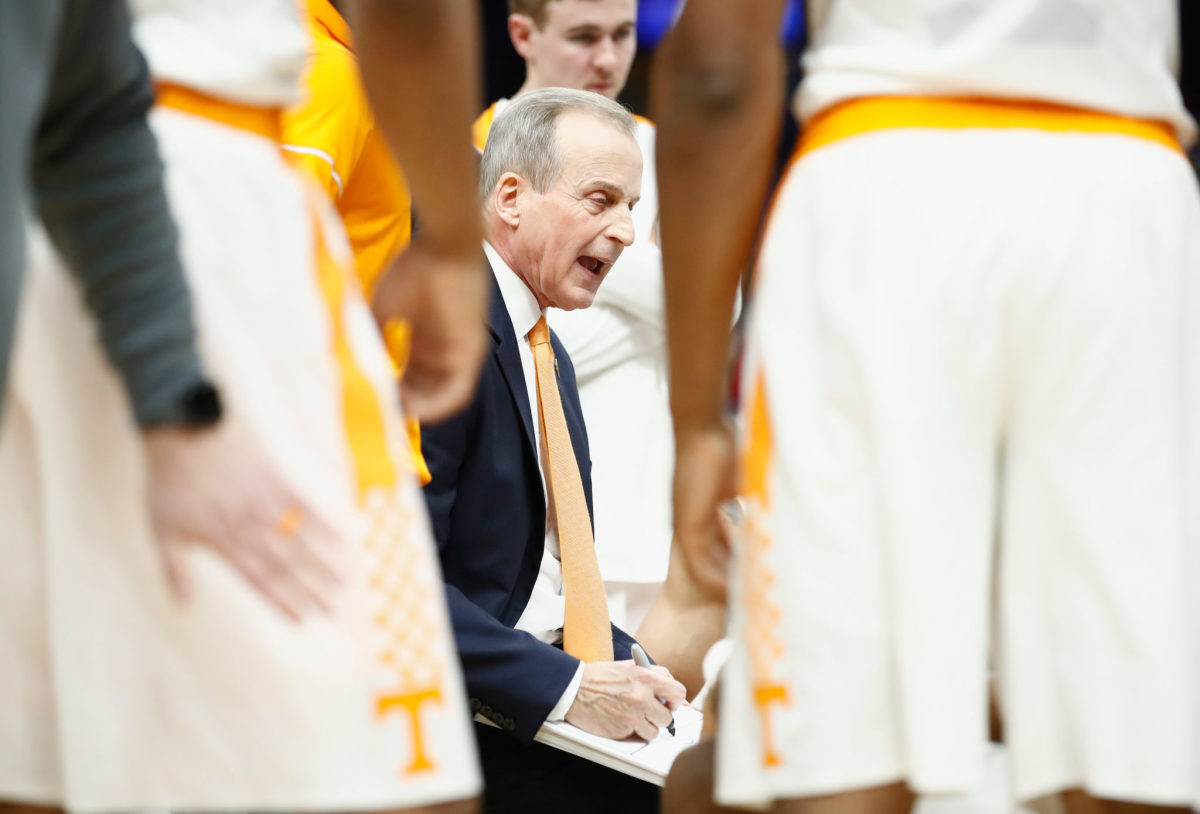 Tennessee coach Rick Barnes diagrams instructions in the huddle.