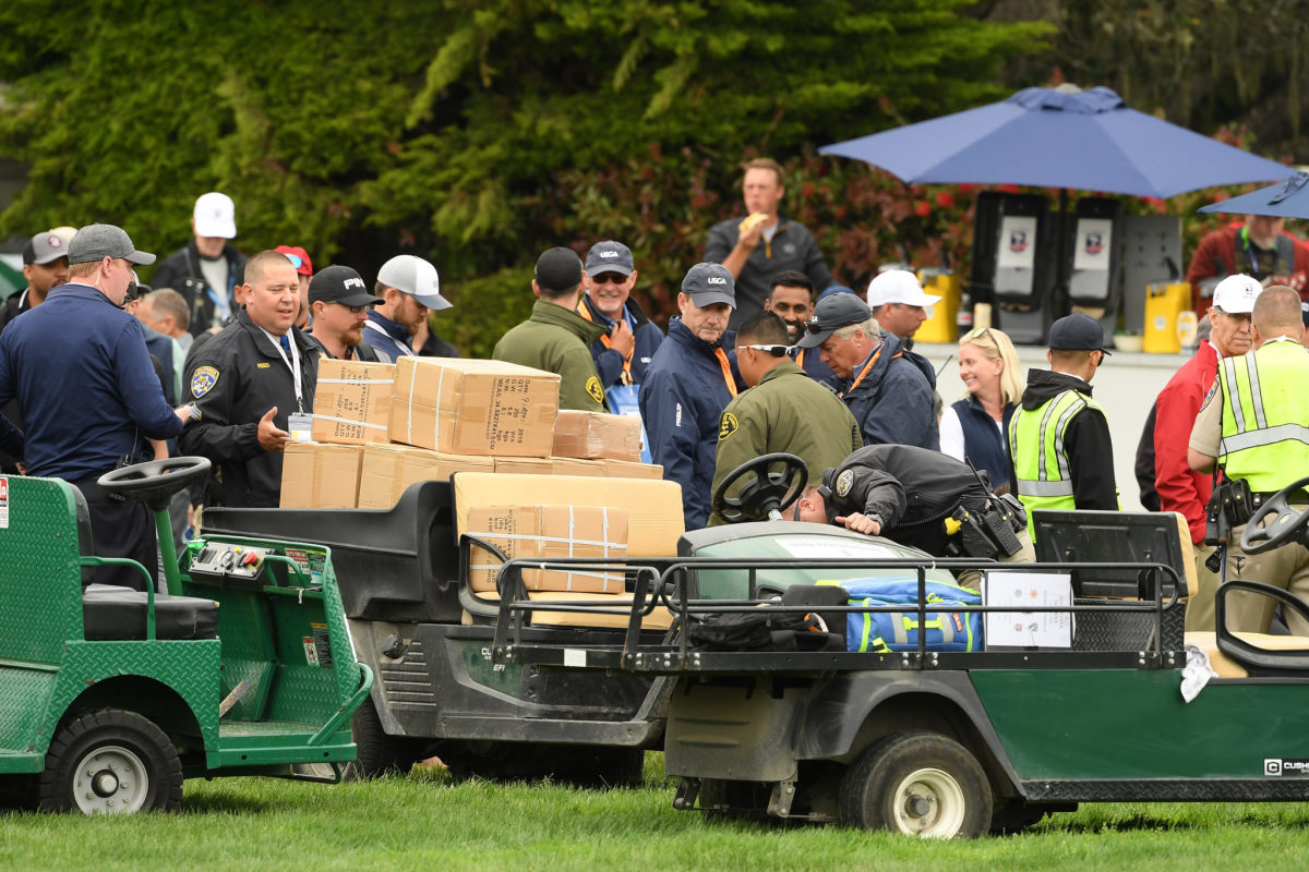 A golf cart loaded with boxes at the U.S. Open.