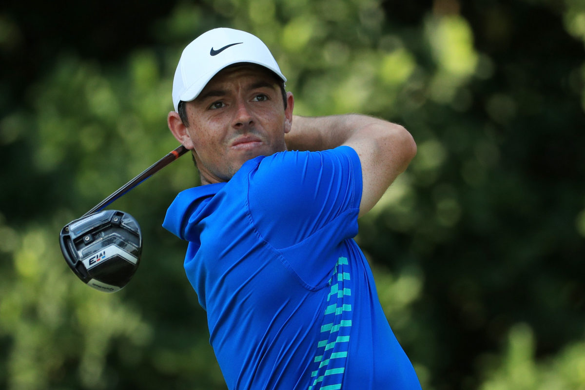 Rory McIlroy following through with his swing.