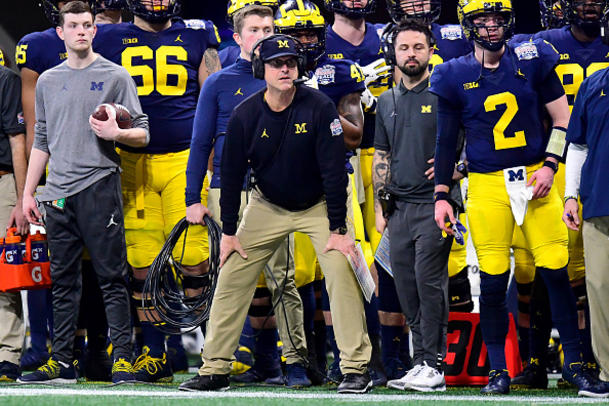A view of Jim Harbaugh on the sideline during a Michigan football game.
