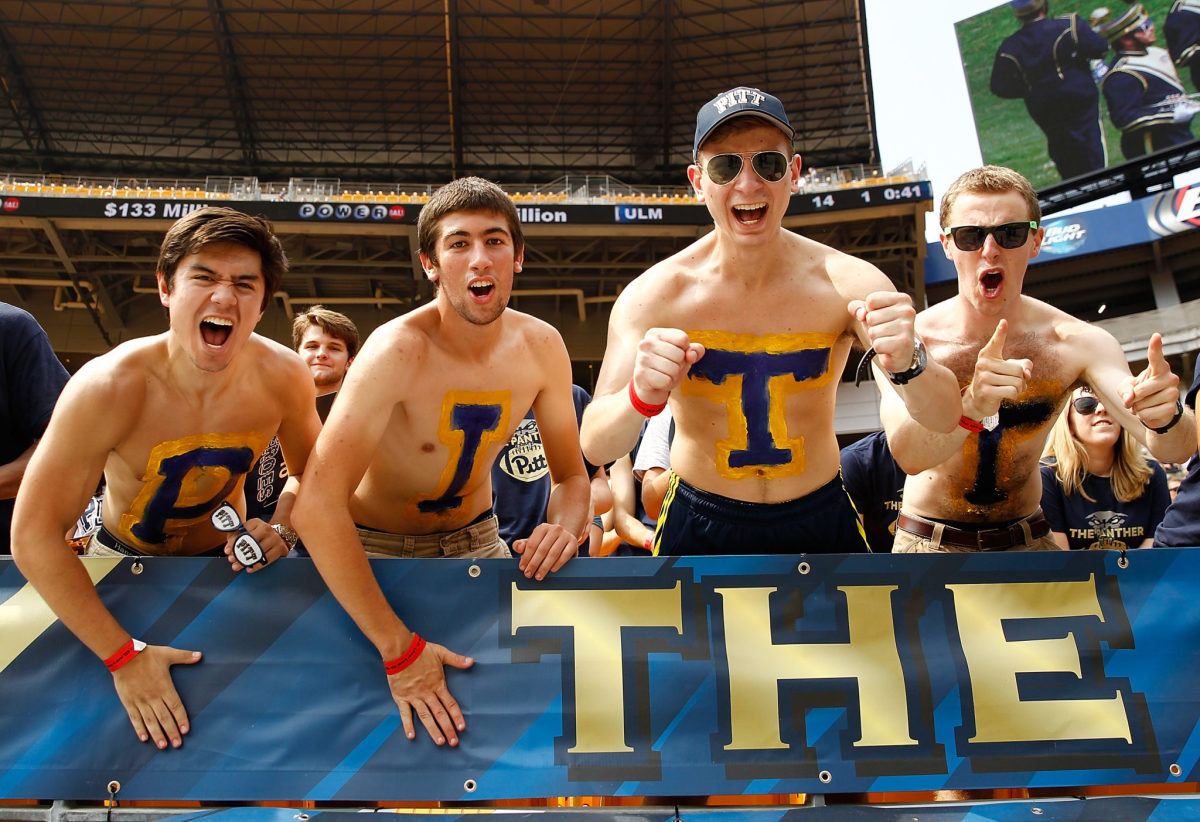 Pitt fans with P-I-T-T painted on their chests.