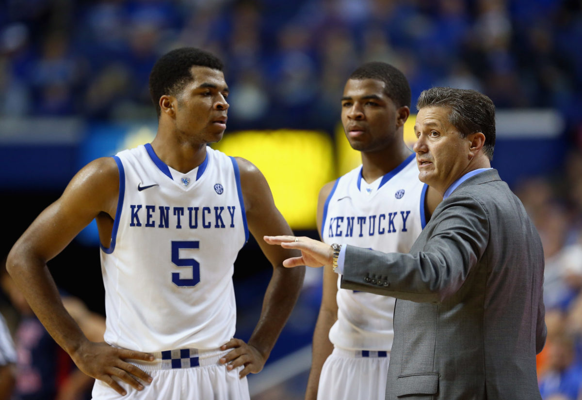 Coach Cal talking to Kentucky's Aaron and Andrew Harrison.