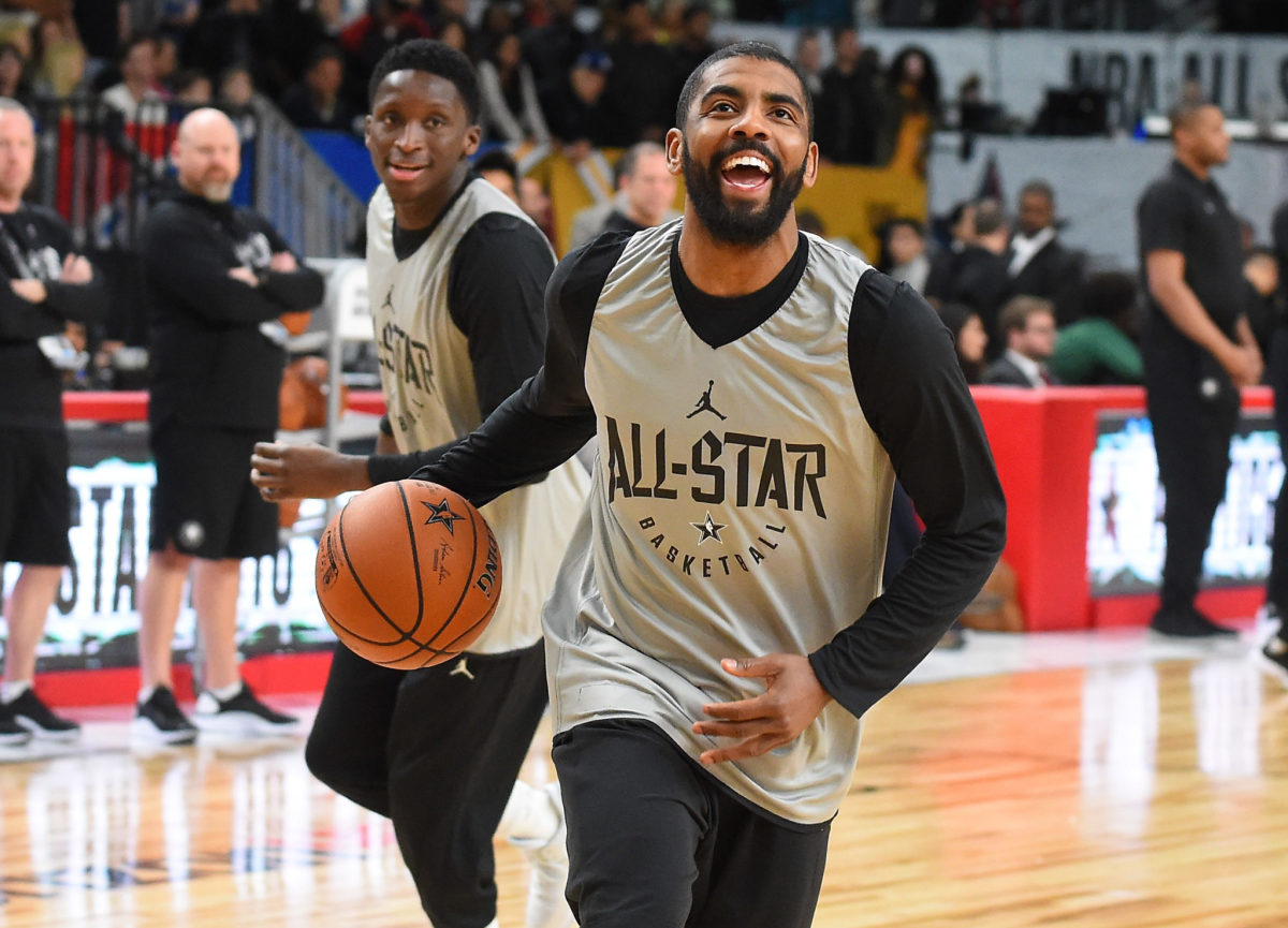 Kyrie Irving smiling during warmups for the NBA All-Star game.