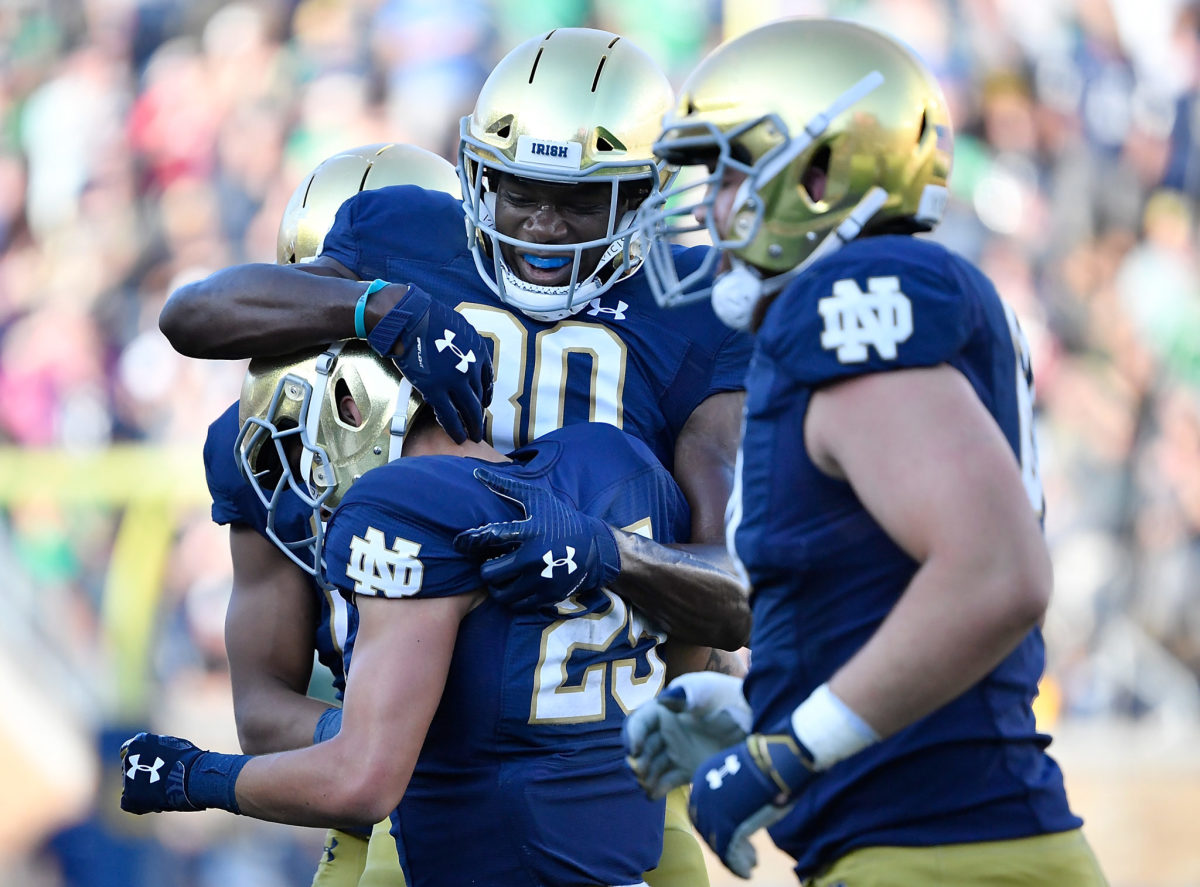 Notre Dame players celebrate with Braden Lenzy after a touchdown.