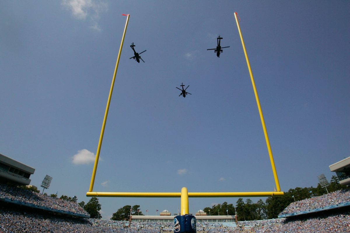 Helicopters fly over Kenan Stadium.