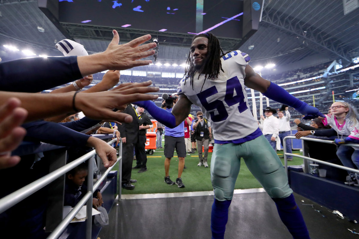 Jaylon Smith slaps hands with Cowboys fans after a game.