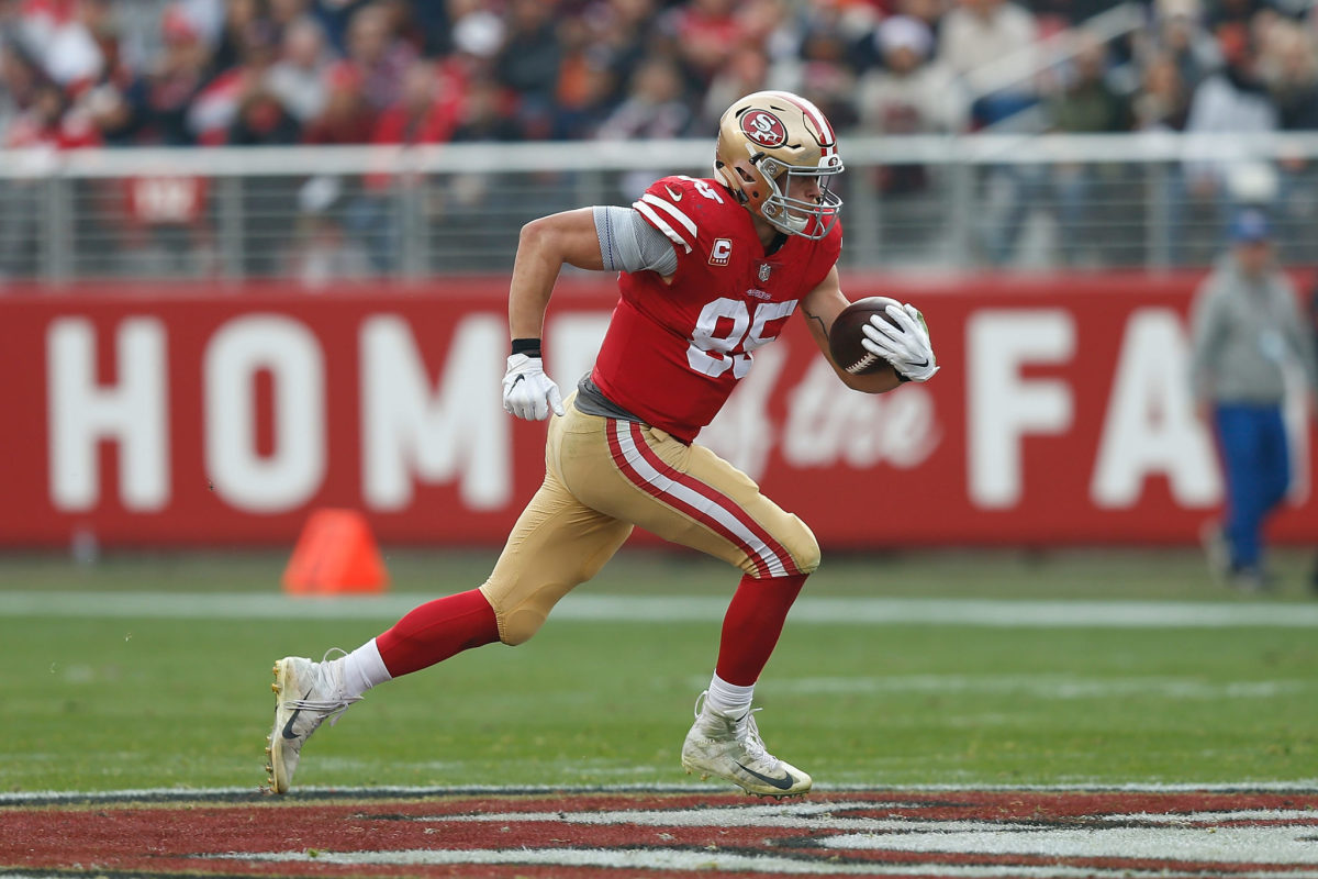 George Kittle running with the football.