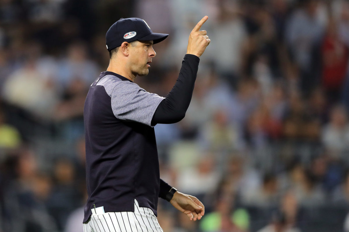 Aaron Boone points to make a pitching change during a game,