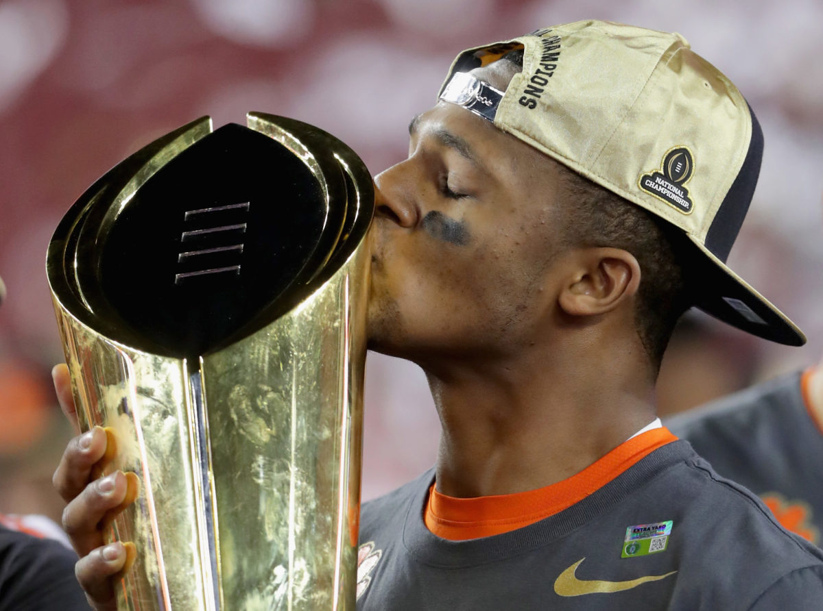 Deshaun Watson of the Clemson Tigers celebrates with the trophy after defeating the Alabama Crimson Tide to win the 2017 College Football Playoff National Championship Game.