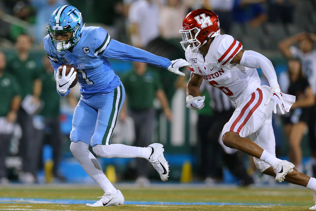 Tulane wide receiver runs away from Houston defender.