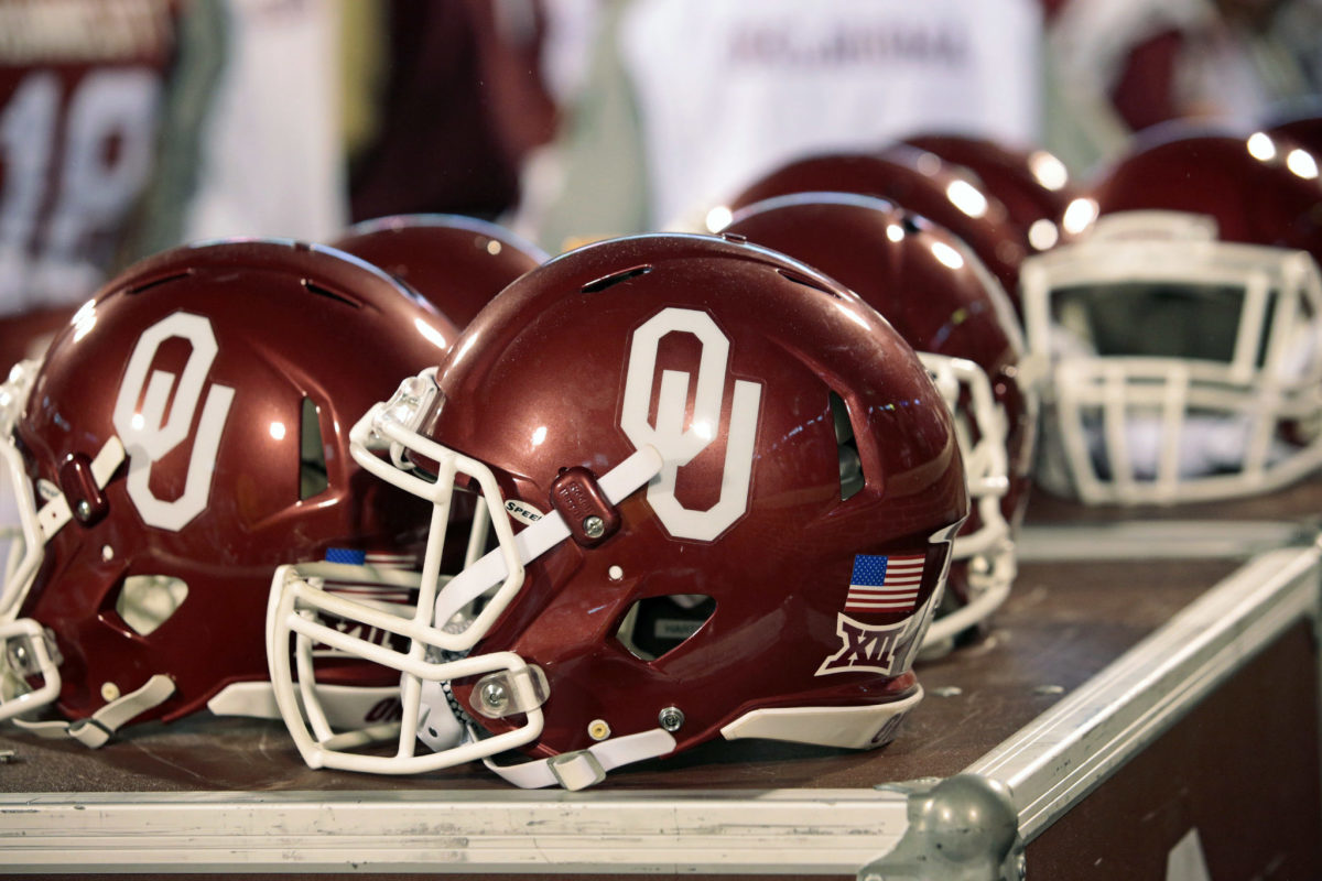 A closeup of an Oklahoma football helmet on the sideline.