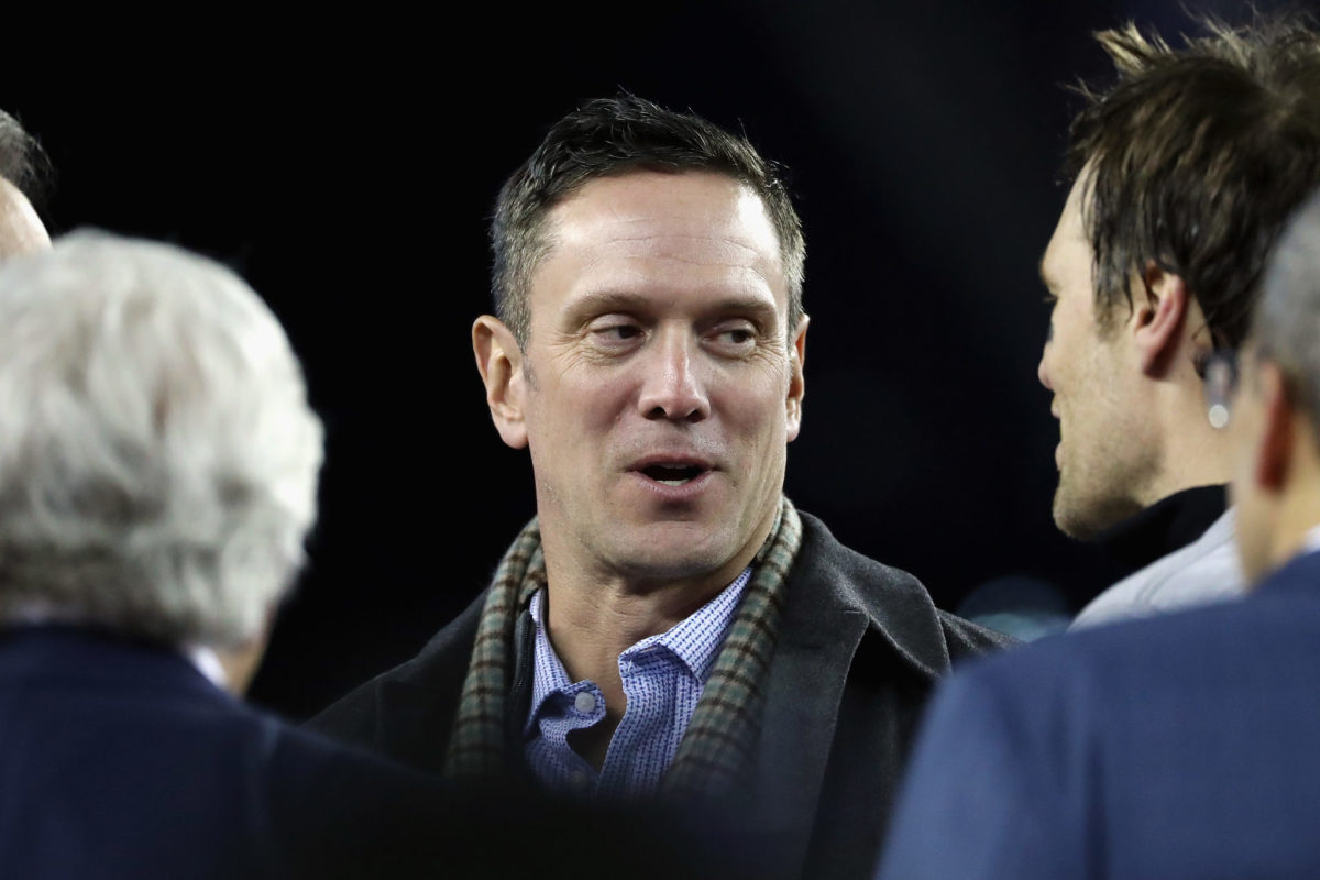 A candid photo of Drew Bledsoe speaking to Tom Brady.