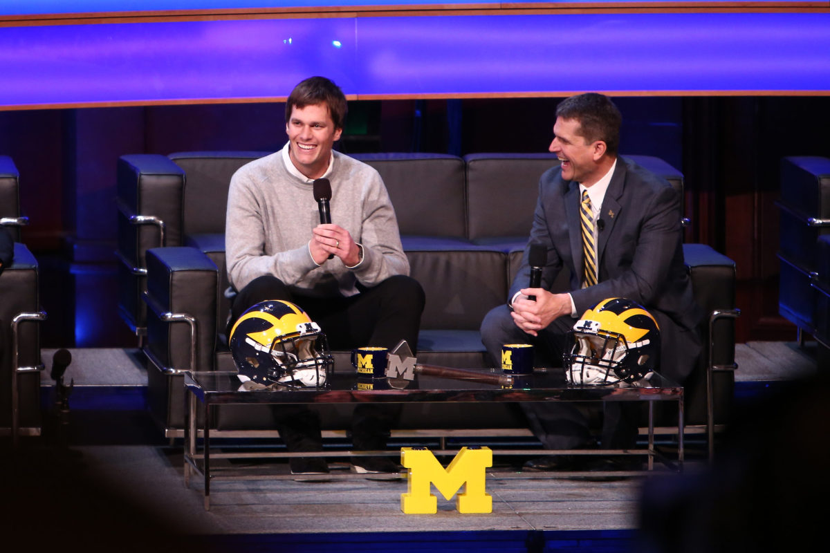 Tom Brady, former Michigan Wolverine and current NFL quarterback talks with Head coach Jim Harbaugh of the Michigan Wolverines.