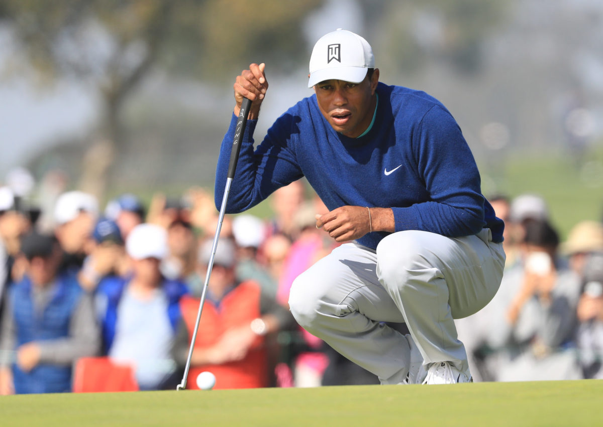 Tiger Woods lines up his putt at the Farmers Insurance Open.