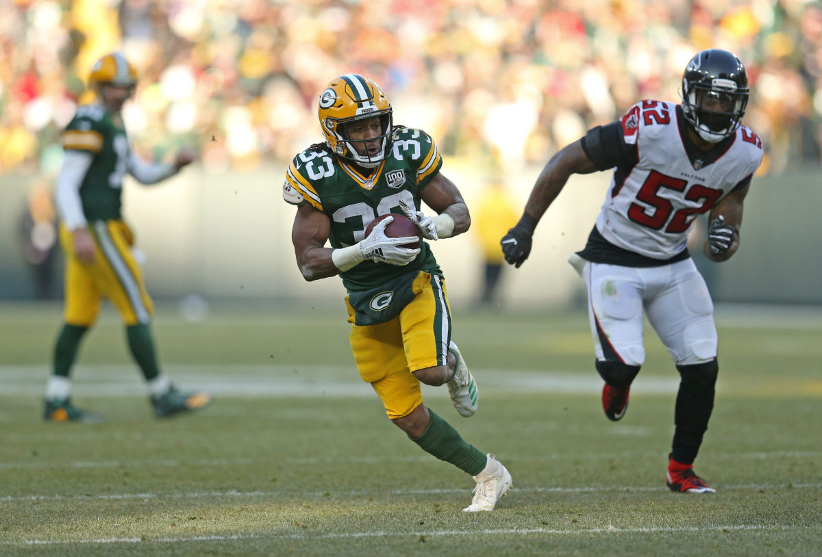 Aaron Jones running with the football for the Green Bay Packers against the Falcons.