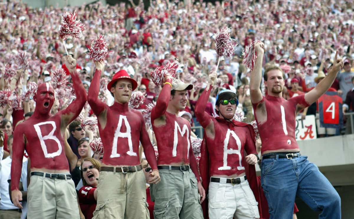 Fans of the University of Alabama Crimson Tide display their body paint during the game with the Louisiana State University Tigers.