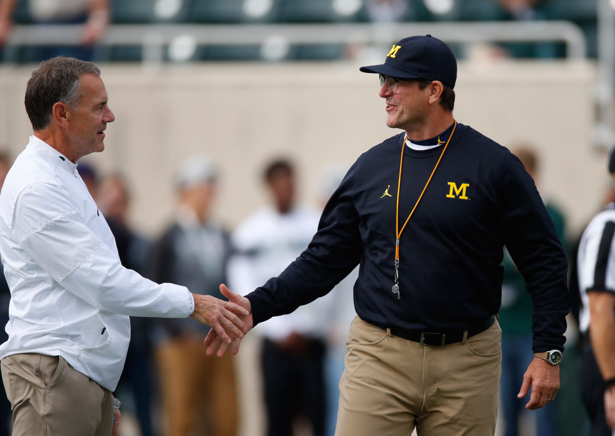 Mark Dantonio and Jim Harbaugh shake hands before a Michigan vs. Michigan State game.